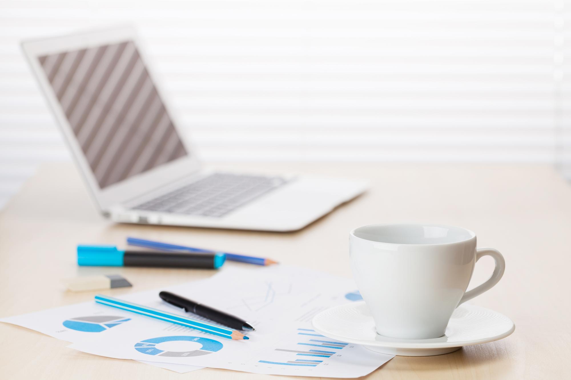 Workspace with documents and coffee