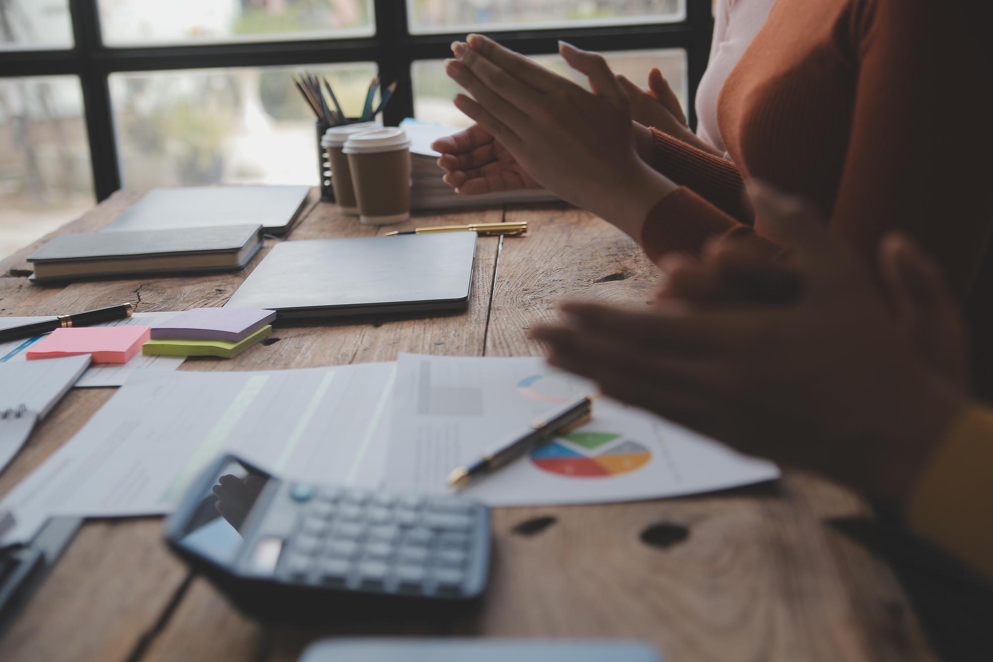 Person reviewing finances with notes on desk